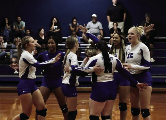 The Wortham volleyball team celebrates during its 3-2 victory against Mart last Friday in Wortham. The Lady Bulldogs finished the first half of District 14-2A play with a 4-0 record. Photo by Jennifer Lansford/Fairfield Recorder