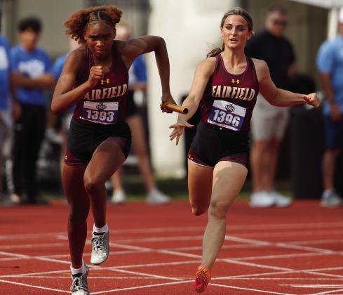 Shadasia Brackens (left) receives a handoff from Madox Mitchael during the Class 3A girls 4x100-meter relay last Thursday in Austin. Courtesy Photo by Scott Coleman