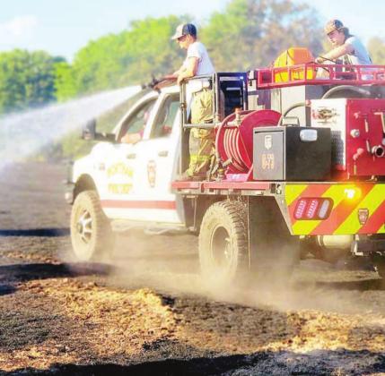 One of many fire trucks rushes to battle a grass fire on CR 1081 near Wortham on Sunday, July 10. Contributed photos from Wortham VFD