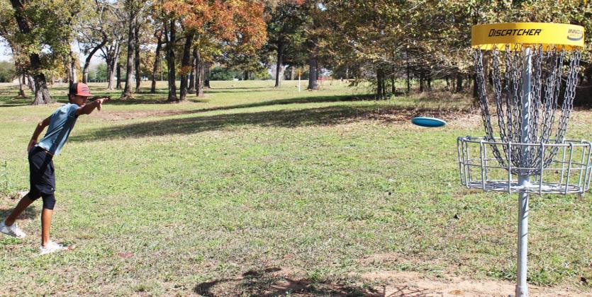 STUDENTS BEGINNING TO USE LOCAL DISC GOLF COURSE