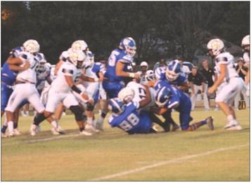 LEFT: Wortham running back Yancey Bean (7) led the Bulldogs in rushing (121 yards, 4 TDs on 5 carries), receiving (3 catches, 60 yards, 2 TDs) and tackles (17) in the Bulldogs’ 63-0 rout of Hubbard last Friday in Wortham. RIGHT: The Bulldog defense limited Hubbard to 75 yards of total offense and five first downs. Photo by Jason Chlapek/Fairfield Recorder